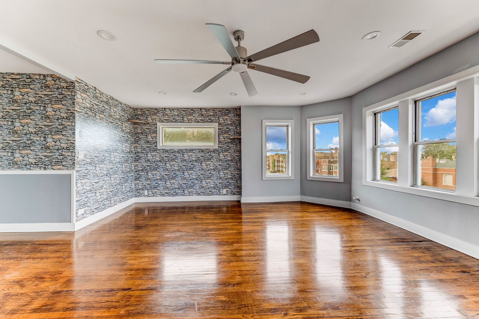 7759 South Constance Avenue Chicago, IL 60649 - Photo 5 of 26 a view of empty room with wooden floor and fan