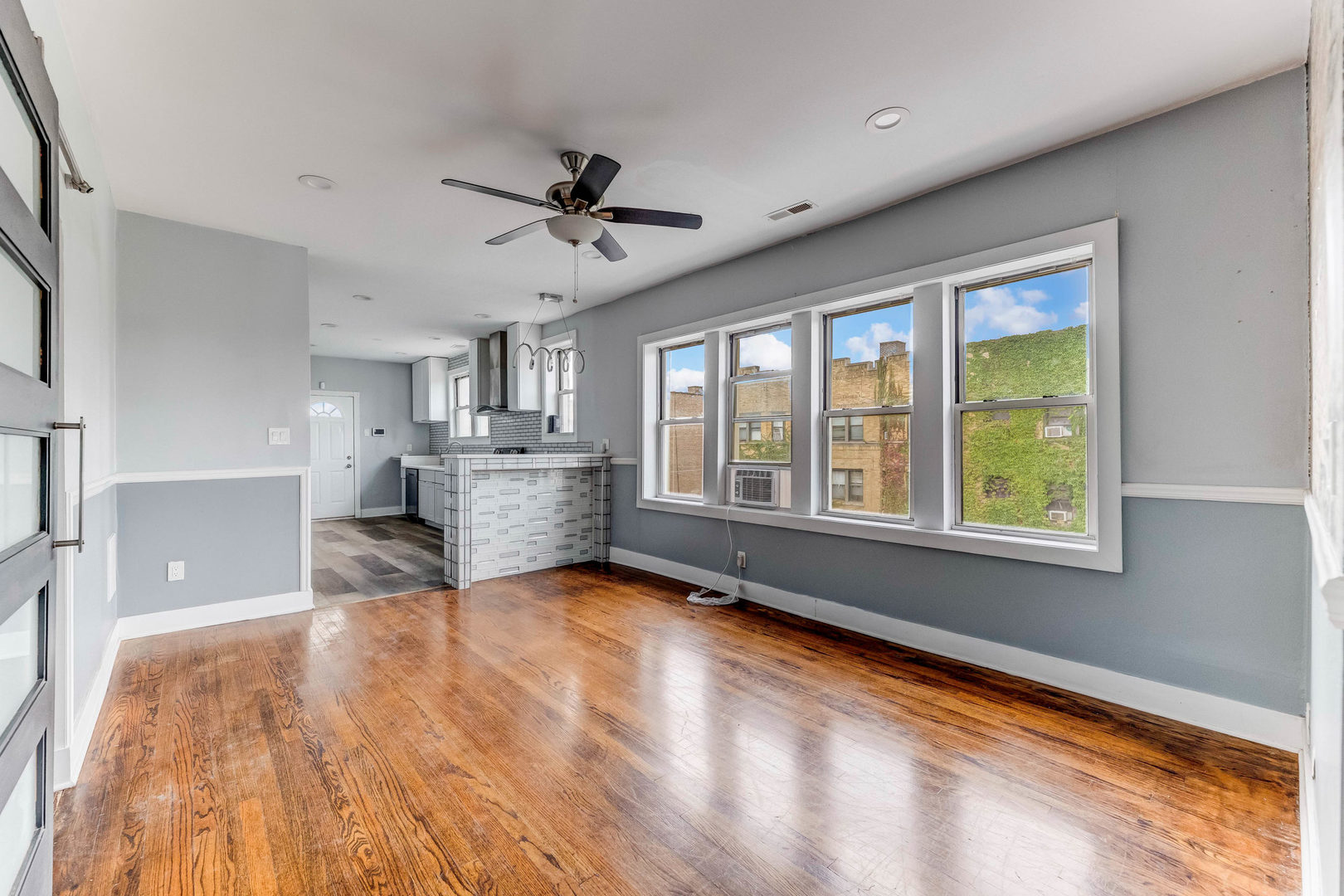 7759 South Constance Avenue Chicago, IL 60649 - Photo 7 of 26 a view of an empty room with a window and kitchen view