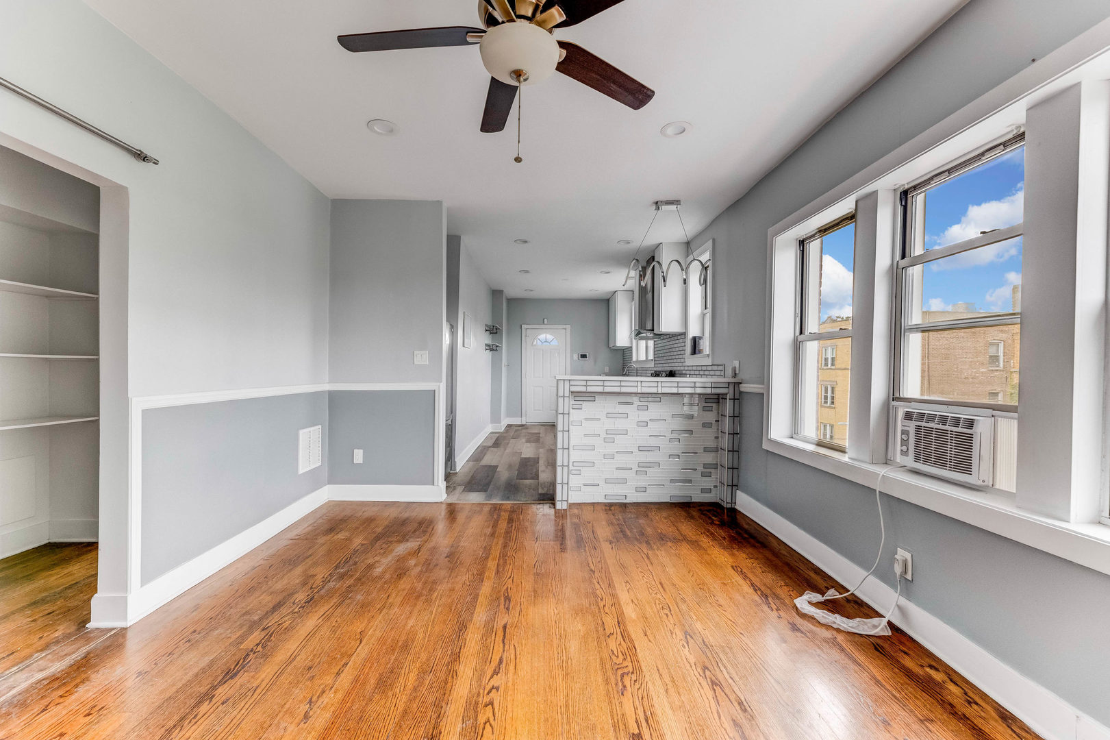 7759 South Constance Avenue Chicago, IL 60649 - Photo 8 of 26 a room with wooden floor and windows