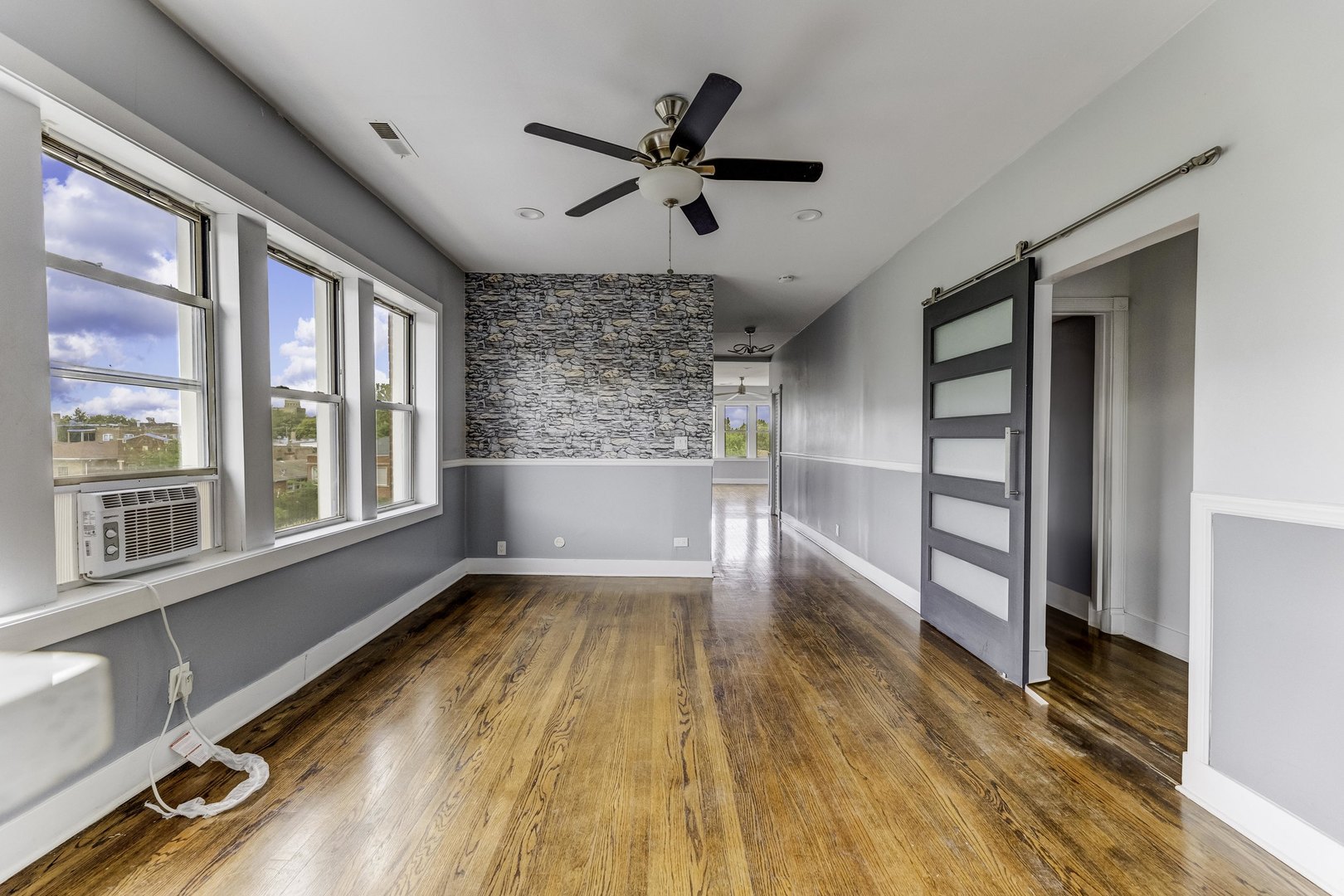 7759 South Constance Avenue Chicago, IL 60649 - Photo 9 of 26 a view of empty room with wooden floor and fan