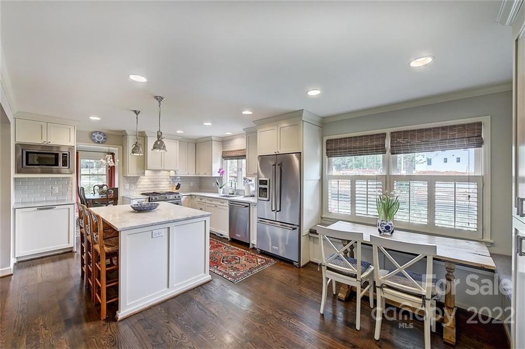 4023 Columbine Circle Charlotte, NC 28211 - Photo 12 of 35 a kitchen with a sink a counter top stainless steel appliances and cabinets