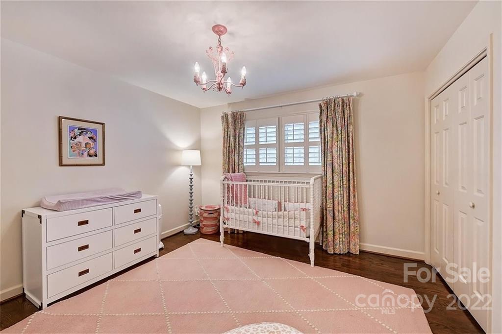 4023 Columbine Circle Charlotte, NC 28211 - Photo 17 of 35 a bedroom with a bed and a chandelier