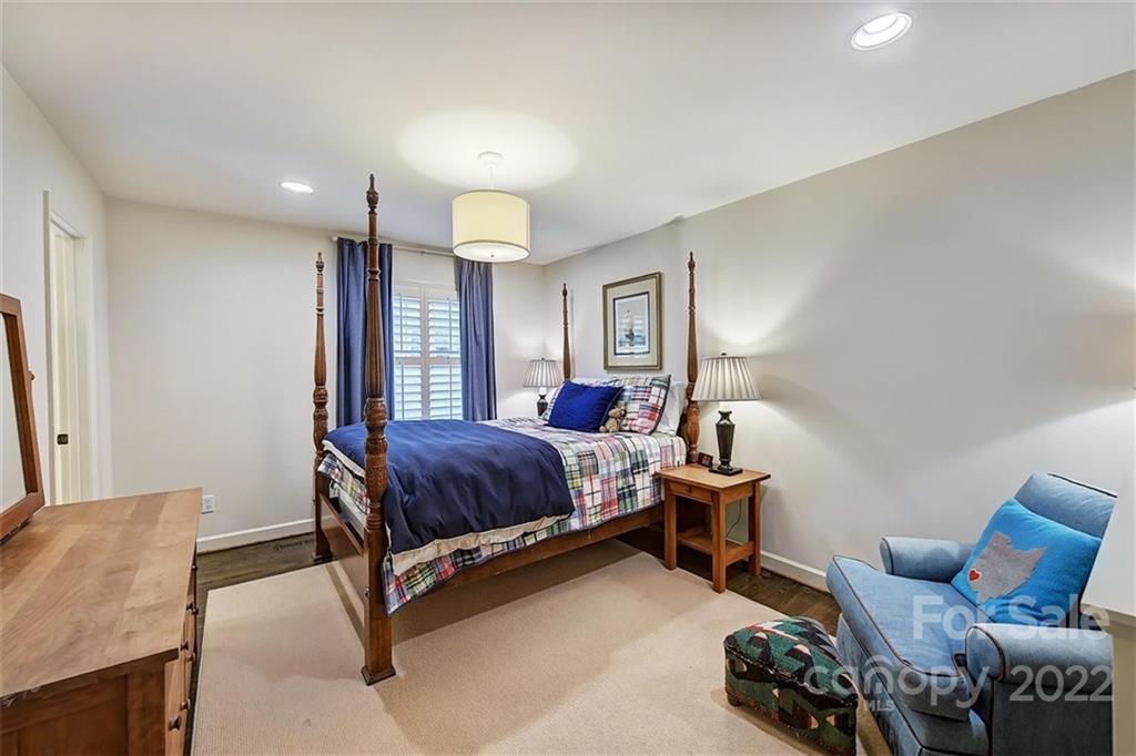 4023 Columbine Circle Charlotte, NC 28211 - Photo 18 of 35 a spacious bedroom with a bed and a couch