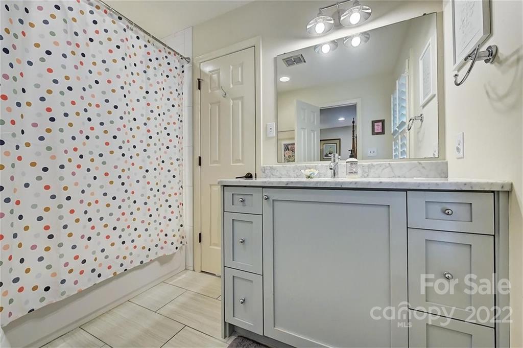 4023 Columbine Circle Charlotte, NC 28211 - Photo 20 of 35 a bathroom with a sink a vanity and a mirror