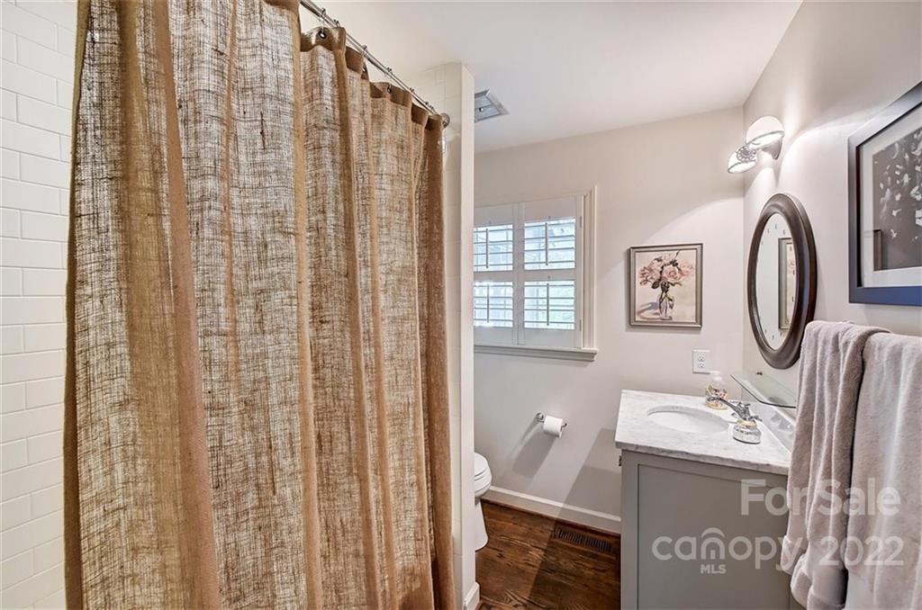 4023 Columbine Circle Charlotte, NC 28211 - Photo 21 of 35 a bathroom with a sink a mirror and shower curtain