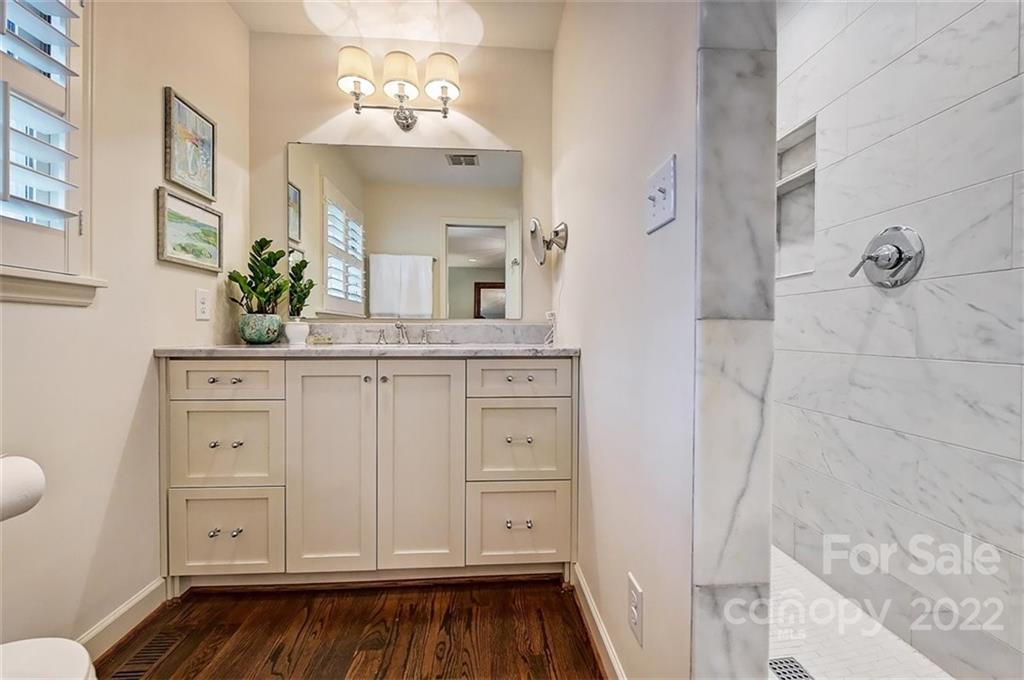 4023 Columbine Circle Charlotte, NC 28211 - Photo 23 of 35 a bathroom with a sink and a mirror