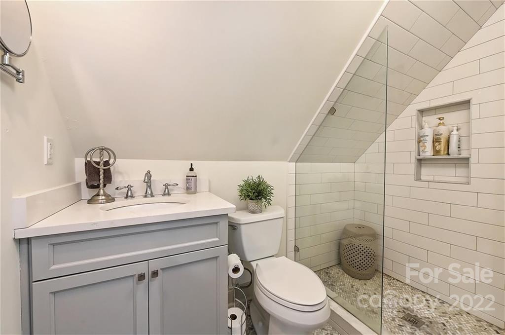 4023 Columbine Circle Charlotte, NC 28211 - Photo 35 of 35 a bathroom with a toilet a sink and mirror