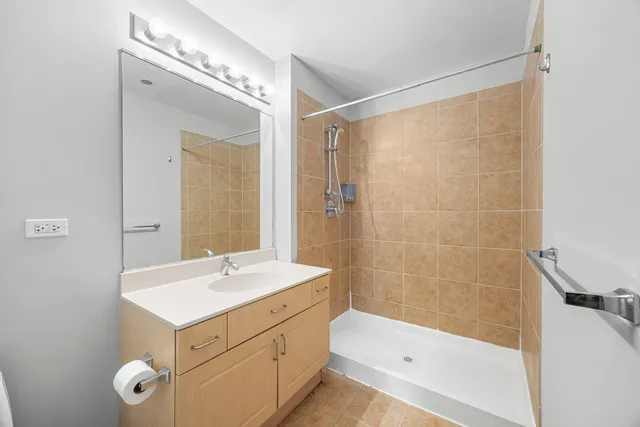 a bathroom with a sink a mirror and a shower