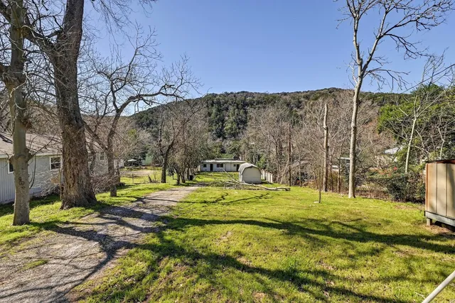 a swimming pool with outdoor seating and yard