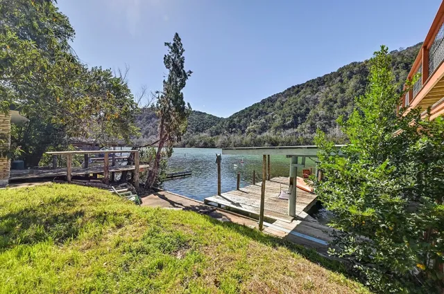 a view of a swimming pool with a patio and a garden