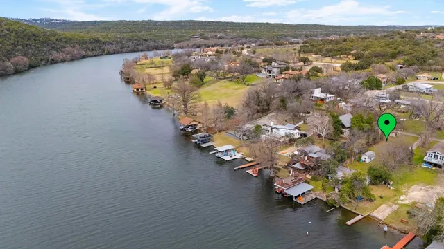 an aerial view of a house with a lake view