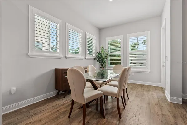 a view of a dining room with furniture and windows
