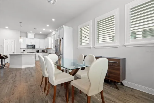 a dining room with furniture and wooden floor