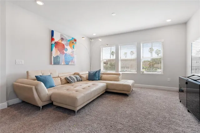 a living room with furniture and large window