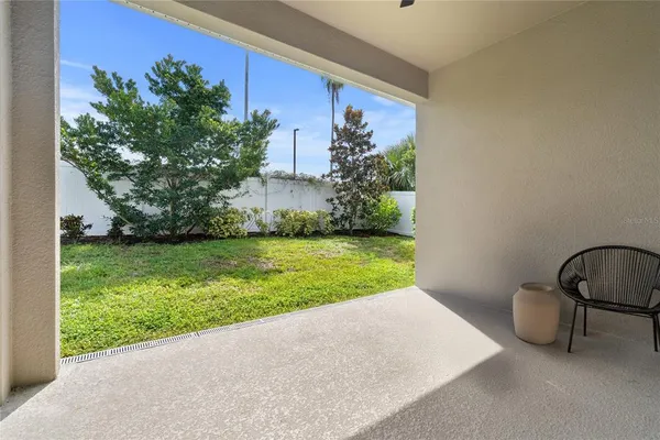 a view of a backyard with potted plants and floor to ceiling window