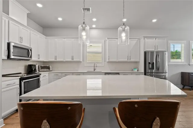 a kitchen with a sink a microwave a stove and refrigerator