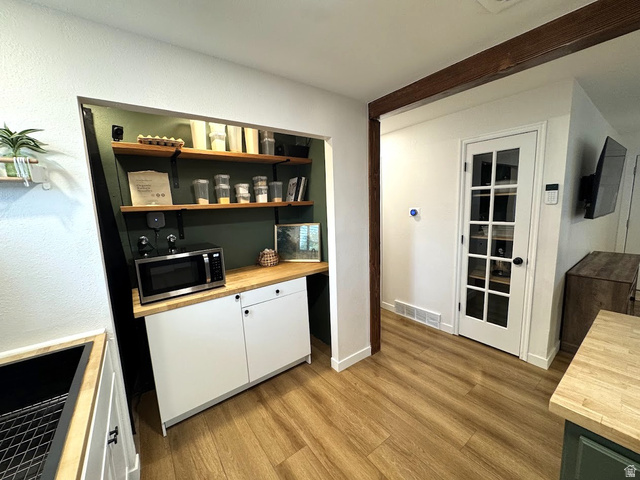 1791 West 170 South, Unit 8 Provo, UT 84601 - Photo 6 of 25 Dedicated pantry area featuring open wood shelving, a butcher block countertop, and white base cabinetry