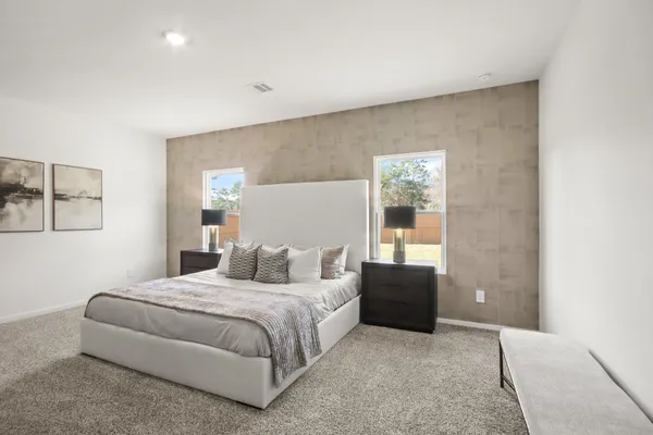 a bedroom with a bed and lamp
