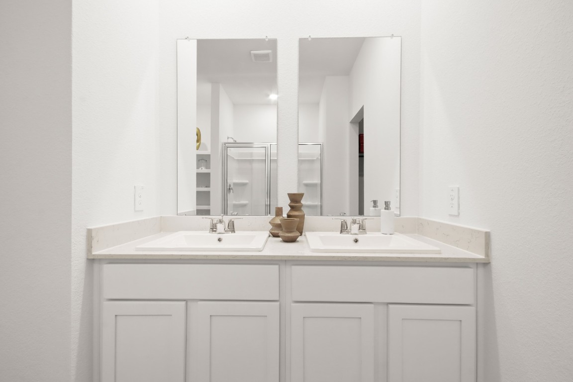 540 Wax Myrtle Way Hockley, TX 77447 - Photo 14 of 25 a bathroom with double sink and a mirror