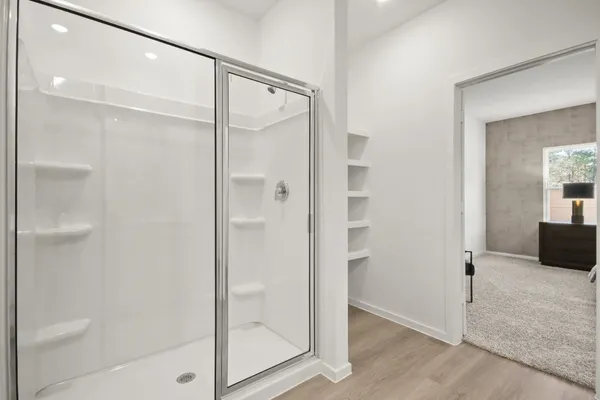 a bathroom with a glass shower door