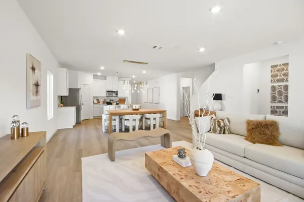 a living room with furniture and kitchen view