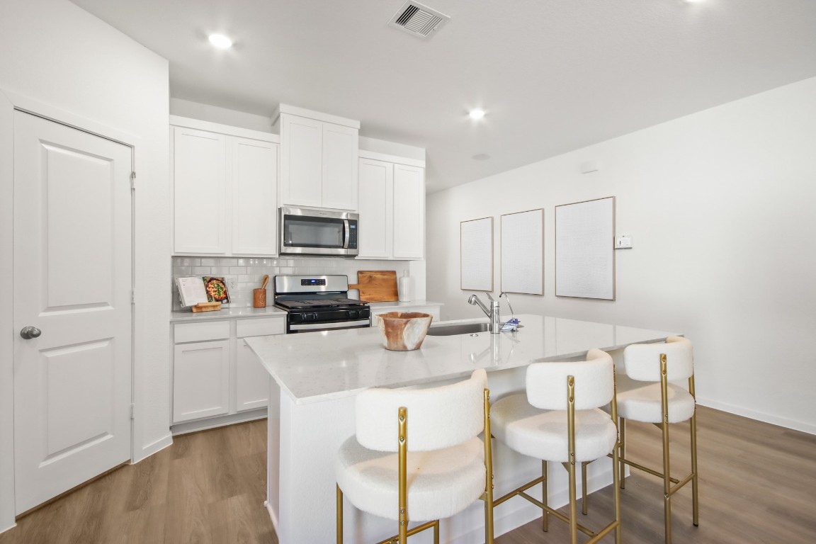 540 Wax Myrtle Way Hockley, TX 77447 - Photo 8 of 25 a kitchen with stainless steel appliances granite countertop a stove top oven a sink dishwasher and a refrigerator