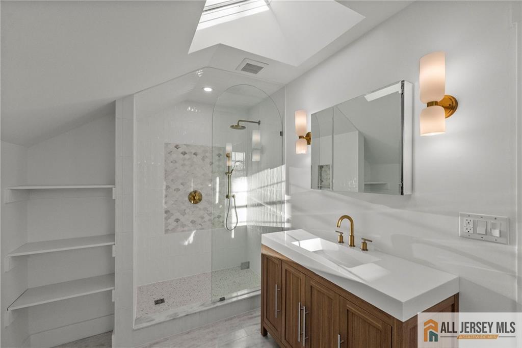 143 Maple Avenue Chester, NJ 07930 - Photo 11 of 52 a bathroom with a sink and a mirror