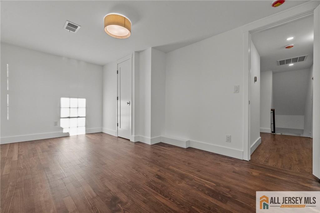 143 Maple Avenue Chester, NJ 07930 - Photo 14 of 52 a view of an empty room with wooden floor and window