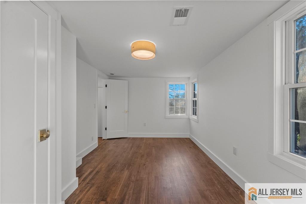 143 Maple Avenue Chester, NJ 07930 - Photo 15 of 52 a view of room with window and wooden floor
