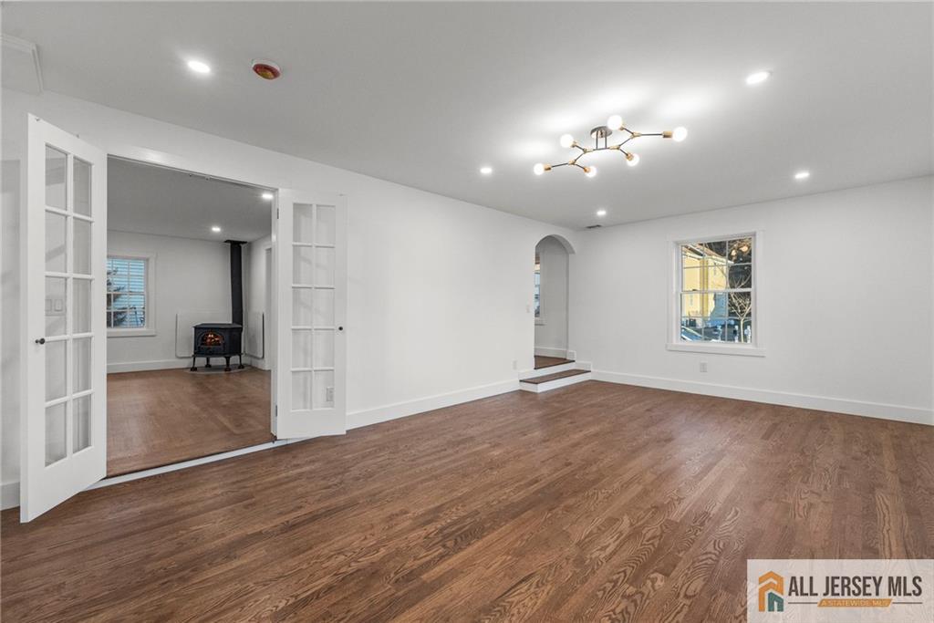 143 Maple Avenue Chester, NJ 07930 - Photo 20 of 52 an empty room with wooden floor and staircase