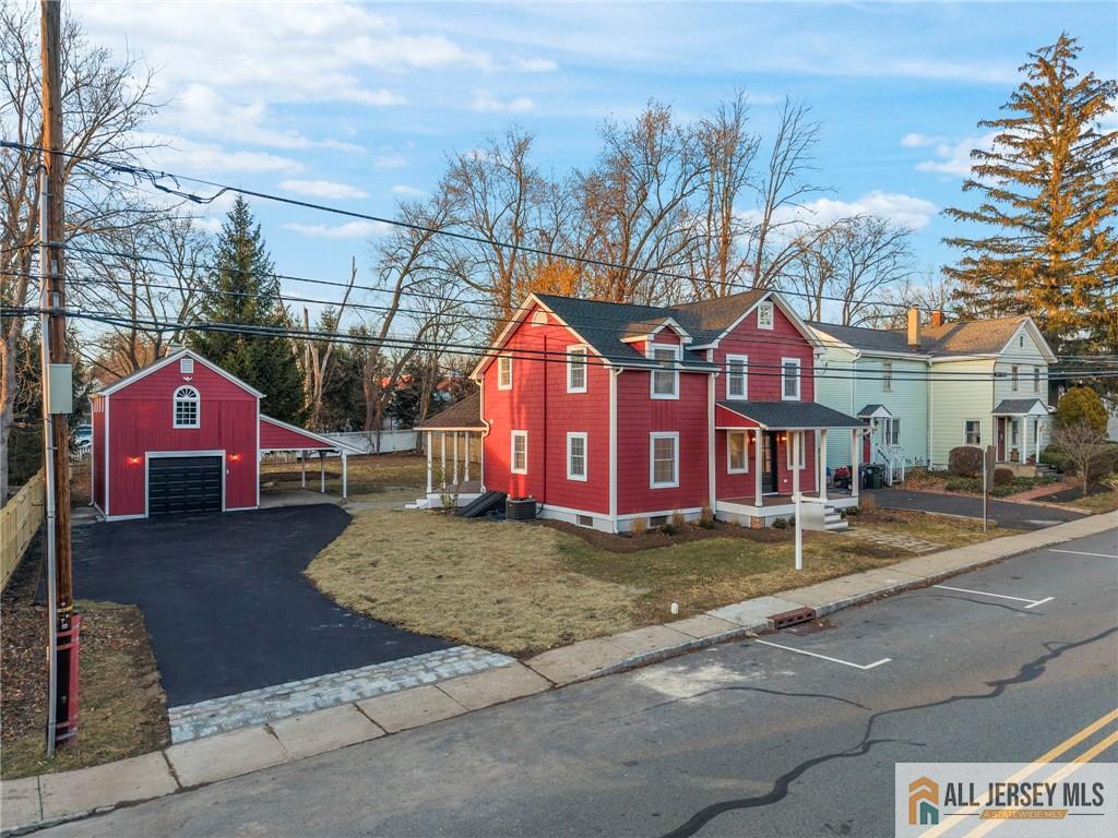 143 Maple Avenue Chester, NJ 07930 - Photo 2 of 52 a front view of a house with a yard and garage