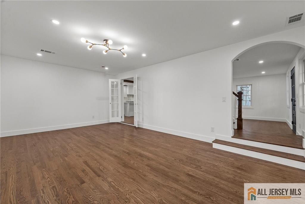 143 Maple Avenue Chester, NJ 07930 - Photo 21 of 52 an empty room with wooden floor and windows