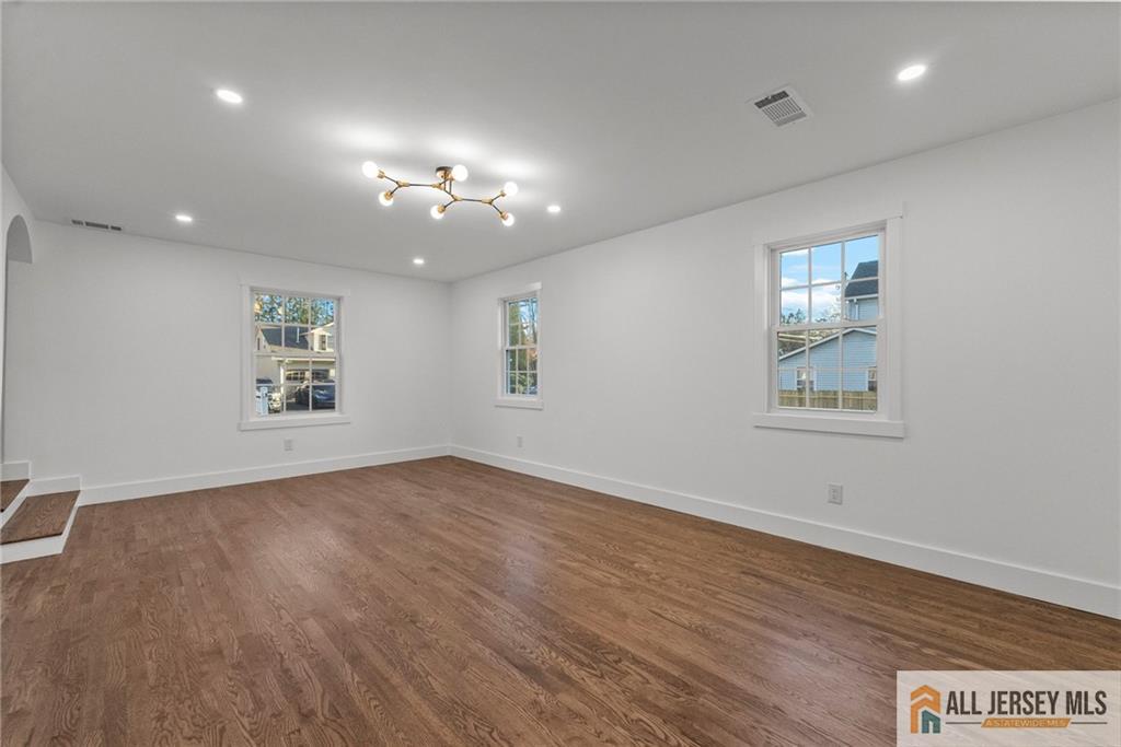 143 Maple Avenue Chester, NJ 07930 - Photo 22 of 52 an empty room with wooden floor and windows