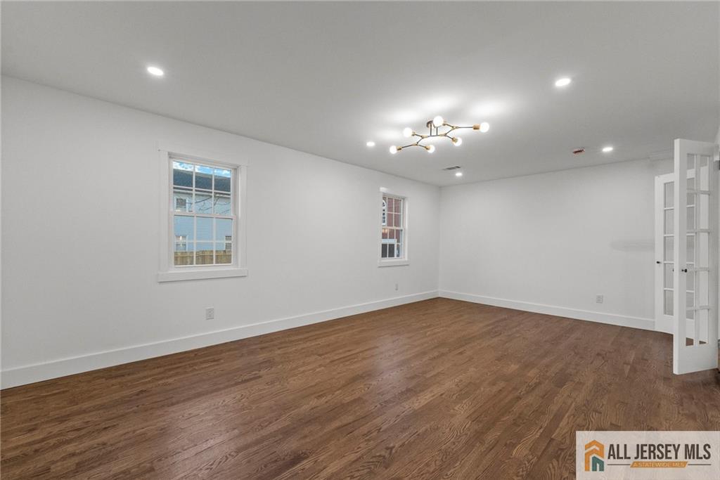 143 Maple Avenue Chester, NJ 07930 - Photo 23 of 52 wooden floor in an empty room with a window