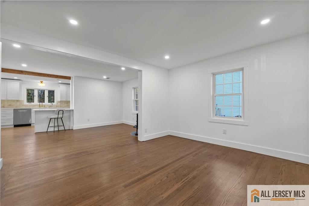 143 Maple Avenue Chester, NJ 07930 - Photo 24 of 52 an empty room with wooden floor and windows
