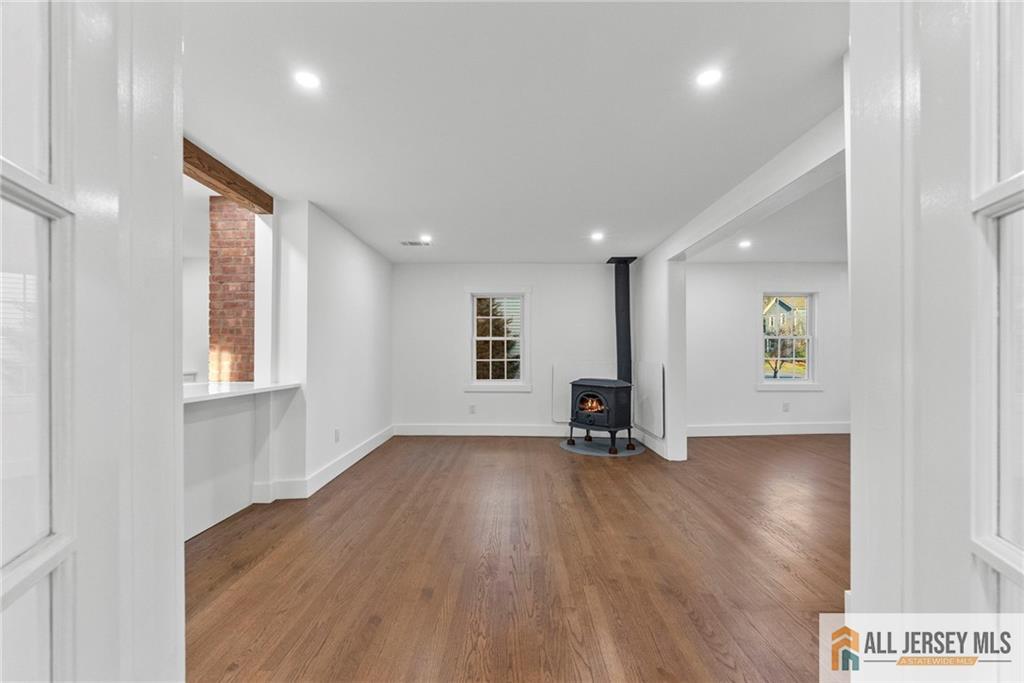 143 Maple Avenue Chester, NJ 07930 - Photo 29 of 52 a view of an empty room with wooden floor and a window