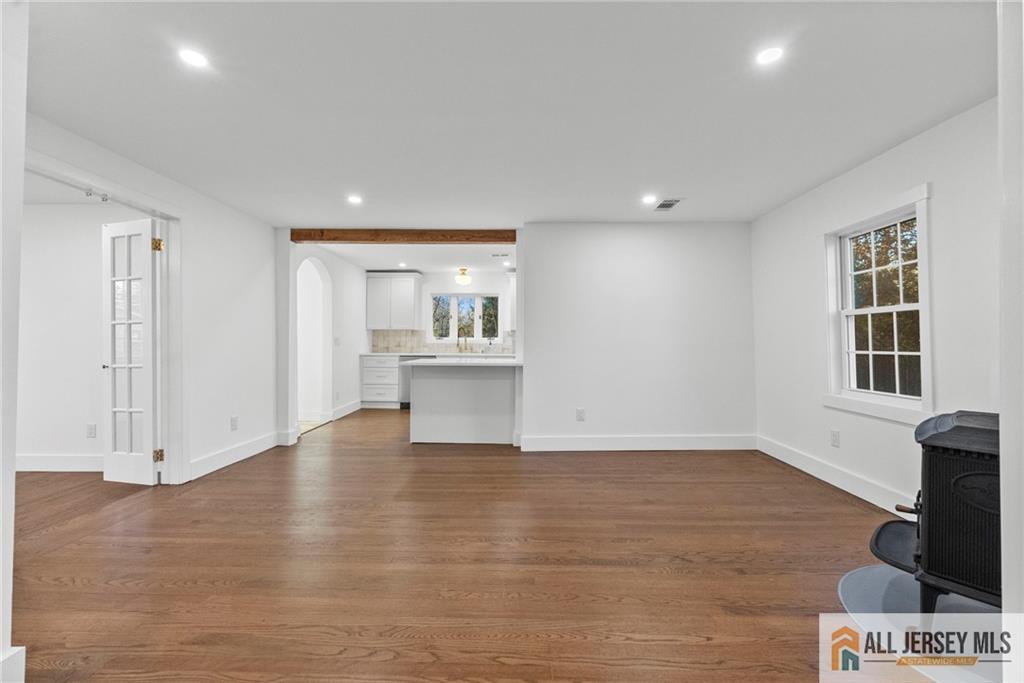 143 Maple Avenue Chester, NJ 07930 - Photo 31 of 52 a view of an empty room with a window and wooden floor