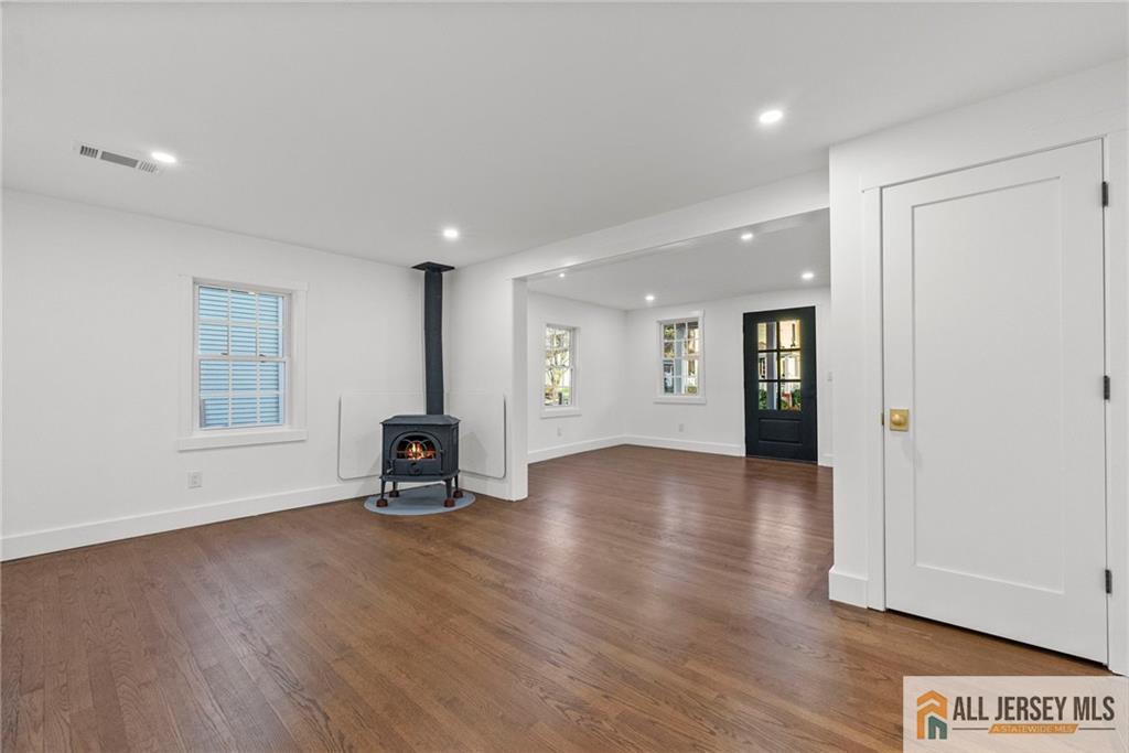 143 Maple Avenue Chester, NJ 07930 - Photo 32 of 52 a view of an empty room with window and wooden floor