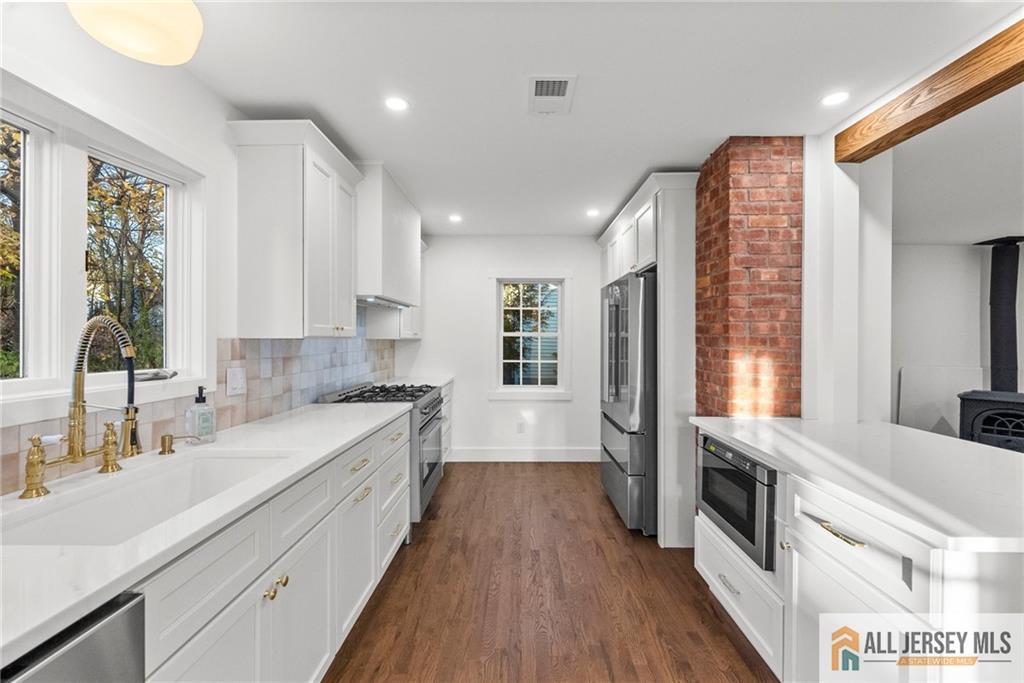 143 Maple Avenue Chester, NJ 07930 - Photo 34 of 52 a kitchen with stainless steel appliances granite countertop a stove a sink and a refrigerator