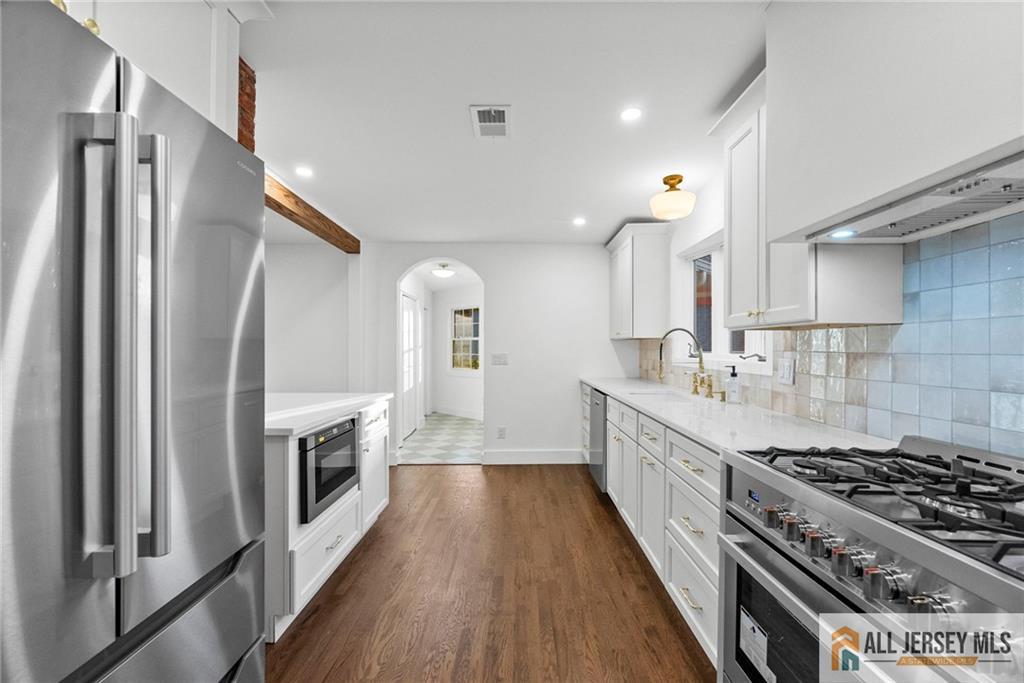 143 Maple Avenue Chester, NJ 07930 - Photo 35 of 52 a large kitchen with a stove and a refrigerator
