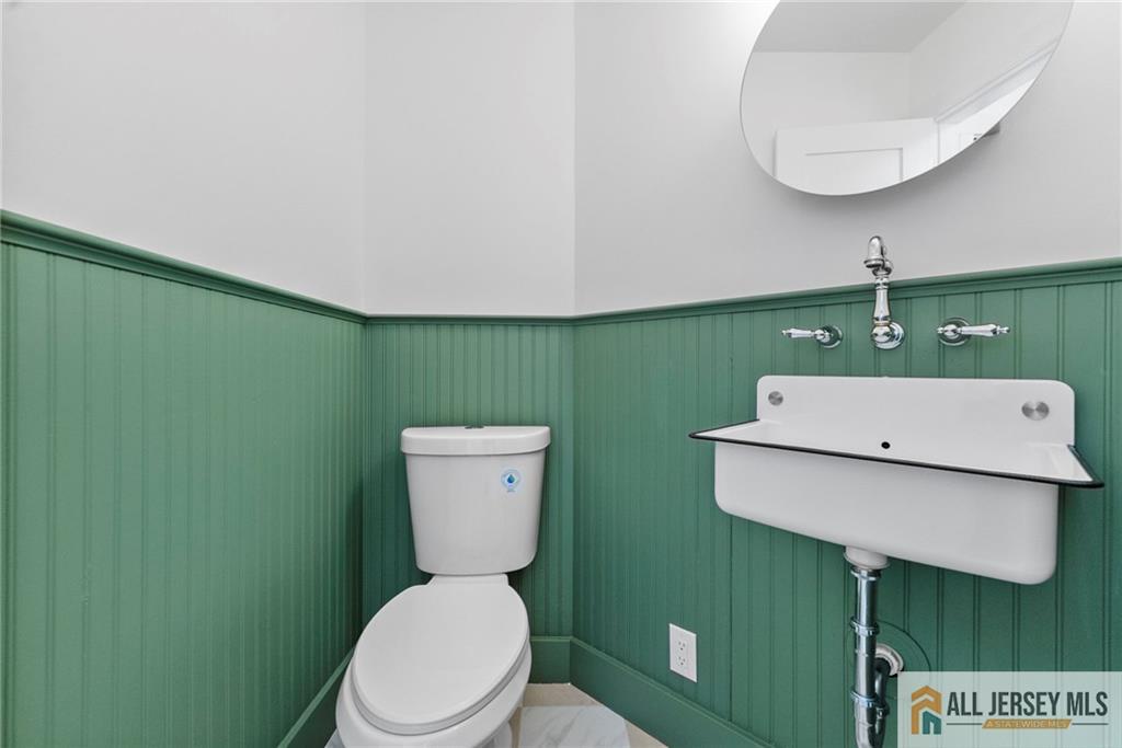 143 Maple Avenue Chester, NJ 07930 - Photo 39 of 52 a bathroom with a toilet and a sink