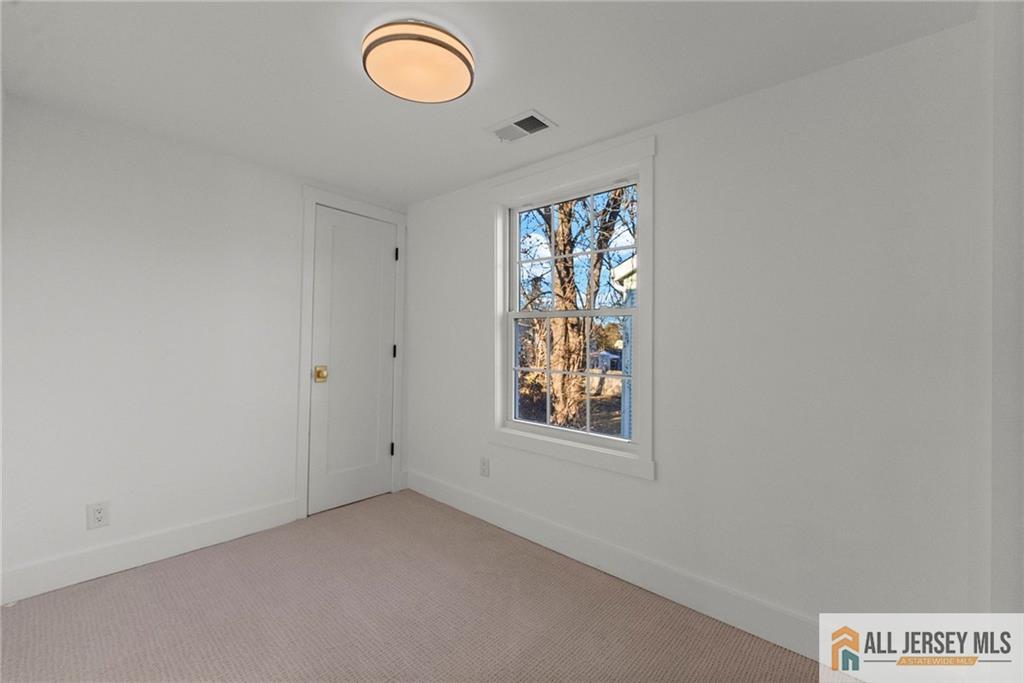 143 Maple Avenue Chester, NJ 07930 - Photo 8 of 52 an empty room with windows and view