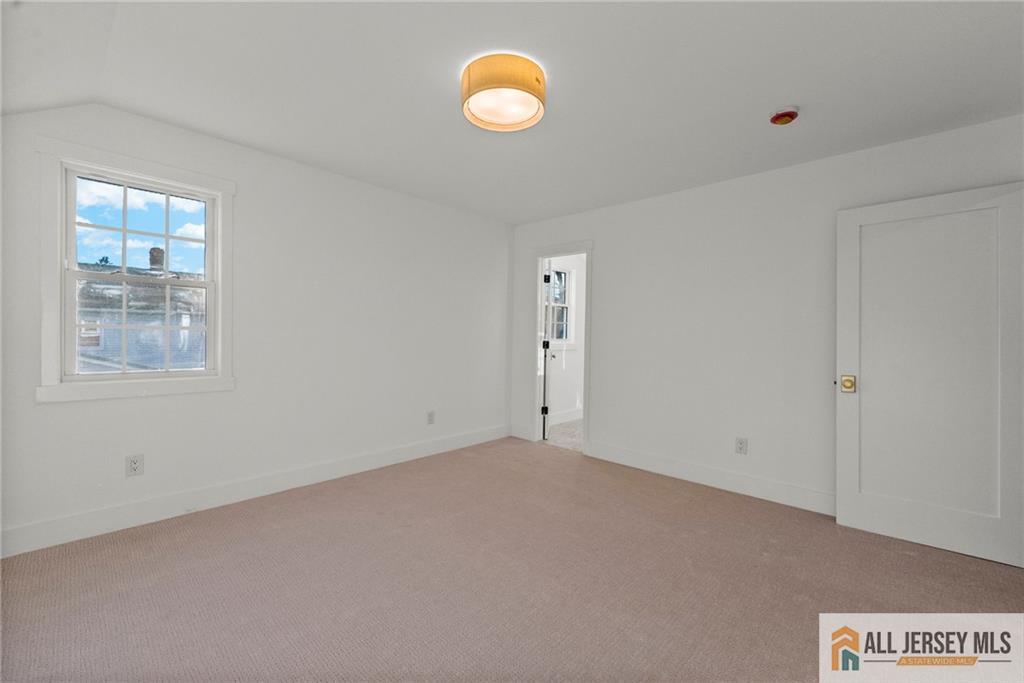 143 Maple Avenue Chester, NJ 07930 - Photo 10 of 52 a view of an empty room with a window