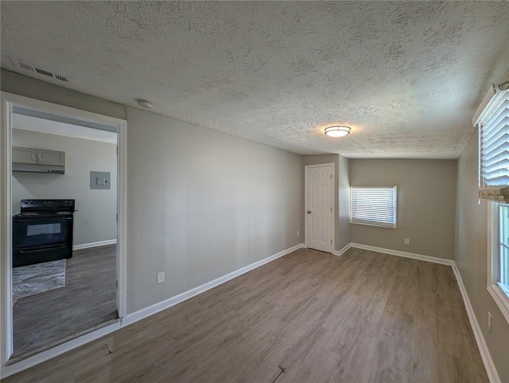 1672 Thornton Place Southwest Atlanta, GA 30315 - Photo 11 of 35 wooden floor in an empty room with a window