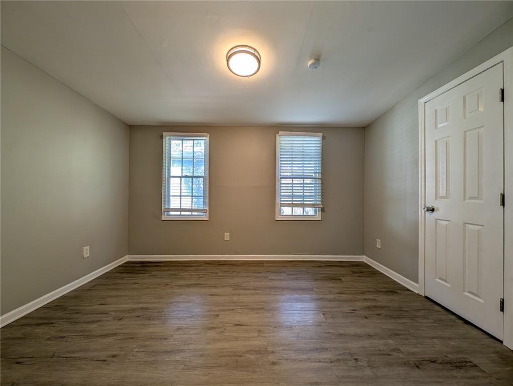 1672 Thornton Place Southwest Atlanta, GA 30315 - Photo 13 of 35 an empty room with wooden floor and windows