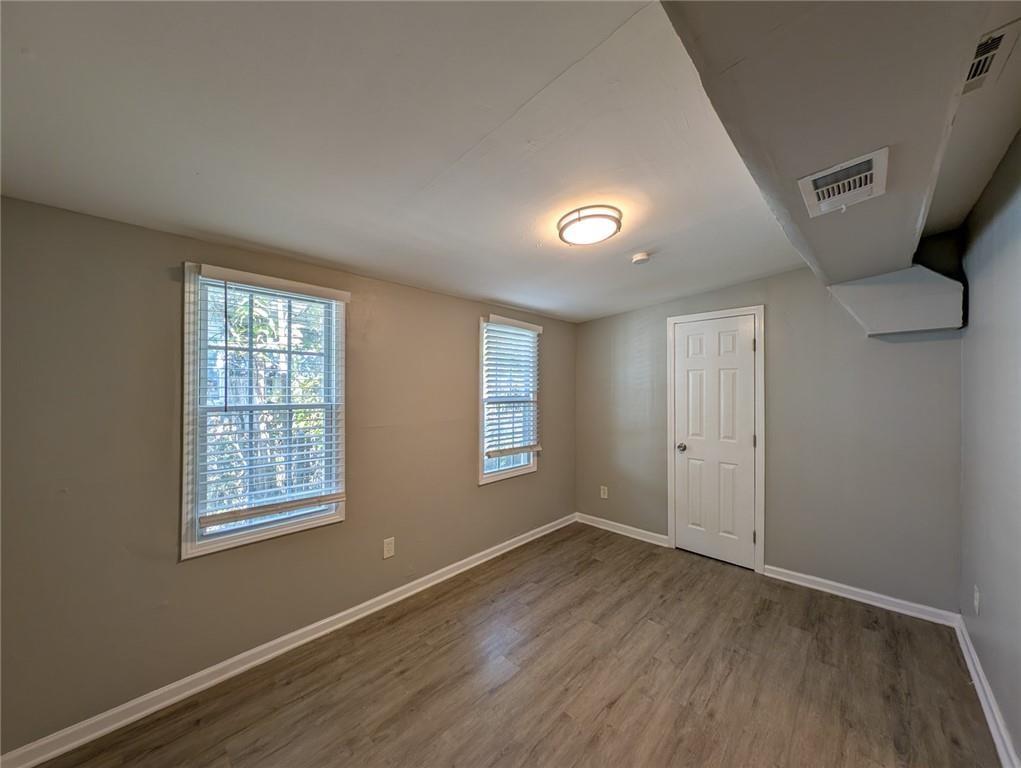 1672 Thornton Place Southwest Atlanta, GA 30315 - Photo 14 of 35 a view of an empty room with wooden floor and a window