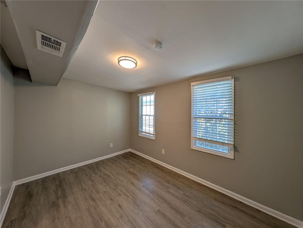 1672 Thornton Place Southwest Atlanta, GA 30315 - Photo 15 of 35 an empty room with wooden floor and windows