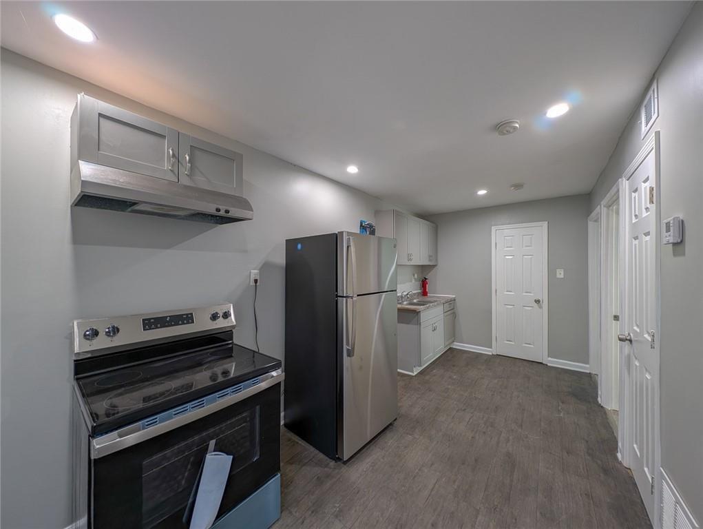 1672 Thornton Place Southwest Atlanta, GA 30315 - Photo 21 of 35 a kitchen with refrigerator and cabinets