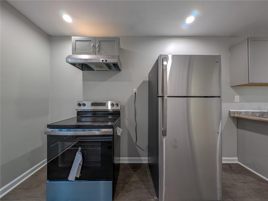 1672 Thornton Place Southwest Atlanta, GA 30315 - Photo 22 of 35 a kitchen with stainless steel appliances a refrigerator and a stove top oven