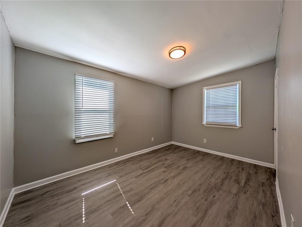 1672 Thornton Place Southwest Atlanta, GA 30315 - Photo 25 of 35 a view of an empty room with wooden floor and a window